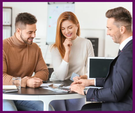 People around a table looking at a calculator