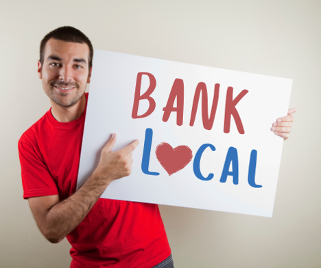 A man holding a sign that says bank local